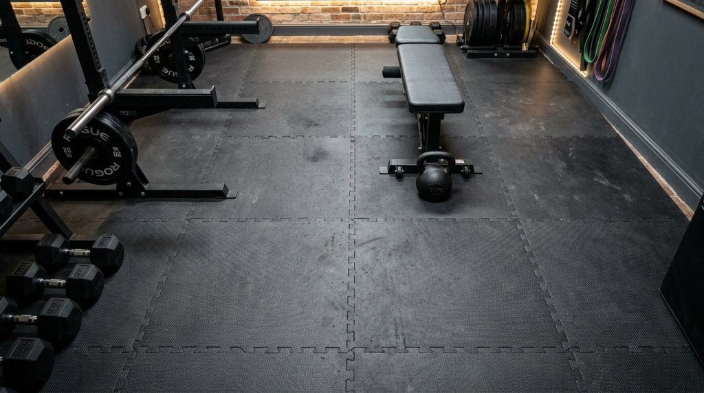 Close-up of black interlocking foam mats installed on a floor surface