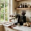 A beautifully organized home coffee station featuring a professional brewing setup and various accessories for a perfect morning caffeine routine.