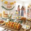 A gourmet selection of snacks displayed on a beautifully decorated baby shower dessert table.